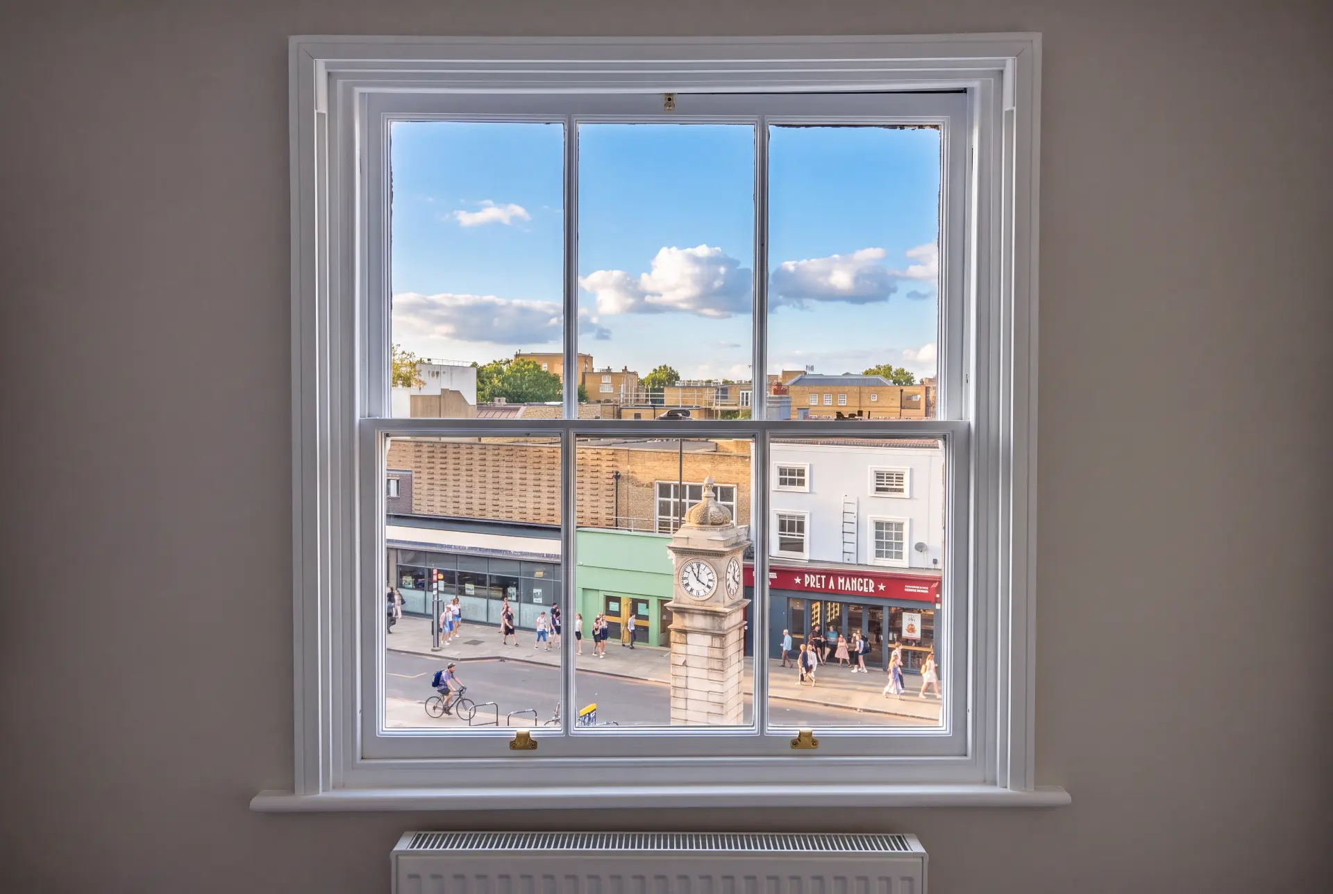 High street frontage — secondary glazing in Camden, London Sash window with secondary glazing overlooking a busy London high street and clock tower