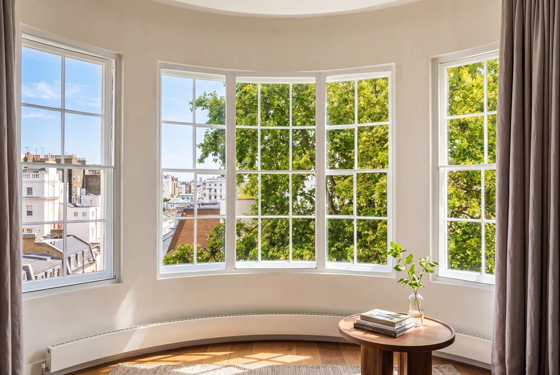 Curved bow bay — secondary glazing in Pimlico, London Curved bow bay window with Georgian bar secondary glazing overlooking London rooftops and trees