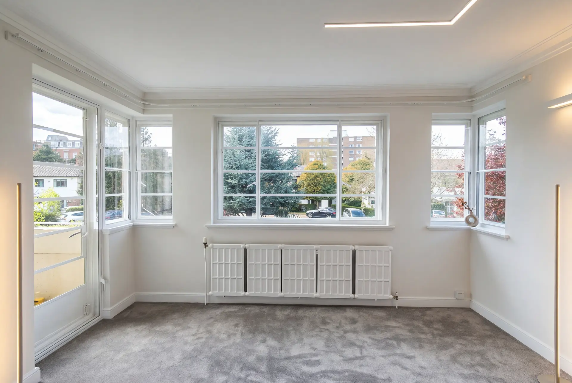 Corner reception room — secondary glazing in Kew, London Bright corner reception room with secondary glazing across bay windows and a balcony door