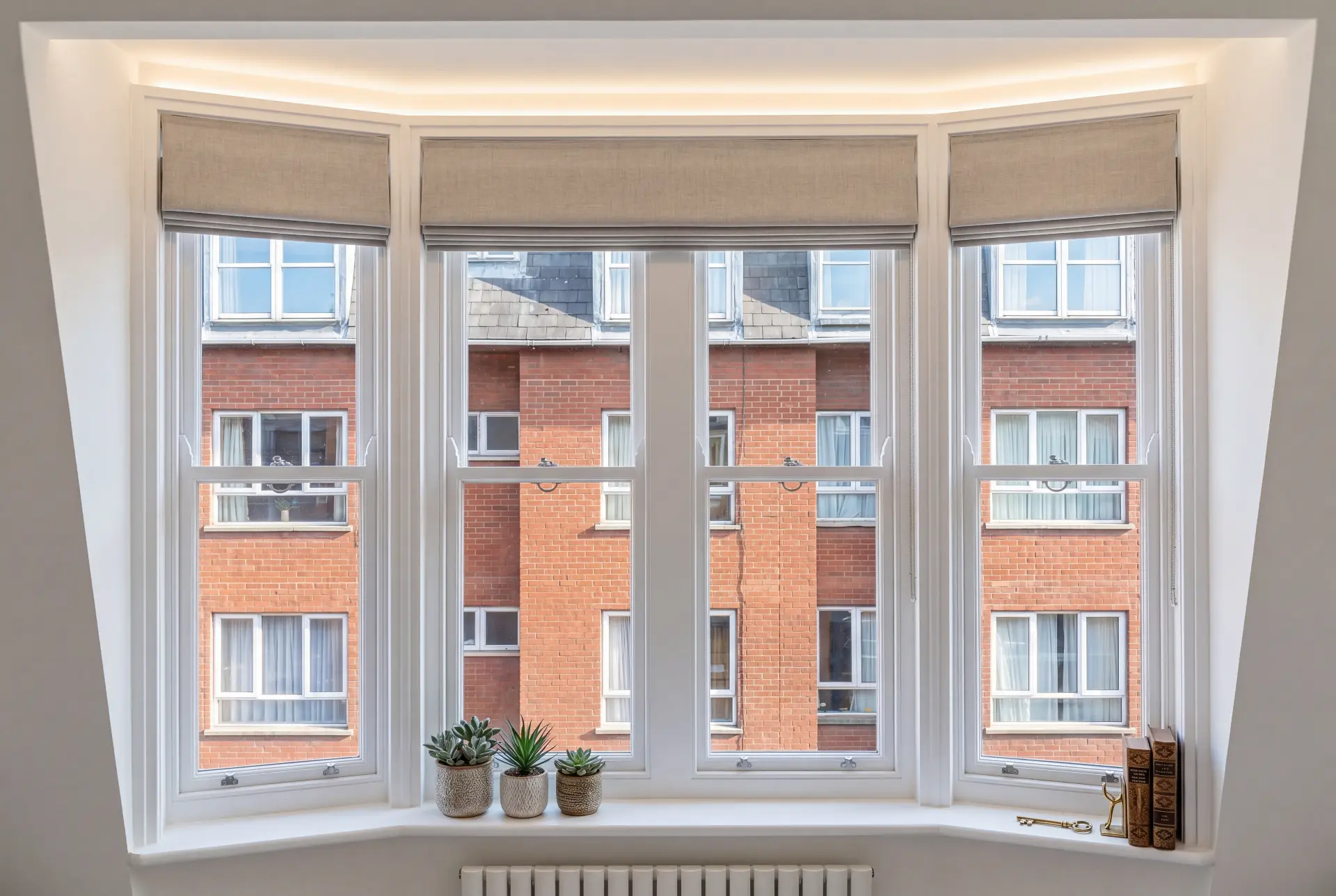 Square bay with blinds — secondary glazing in Chelsea, London Square bay window with four secondary glazed sashes and linen roman blinds