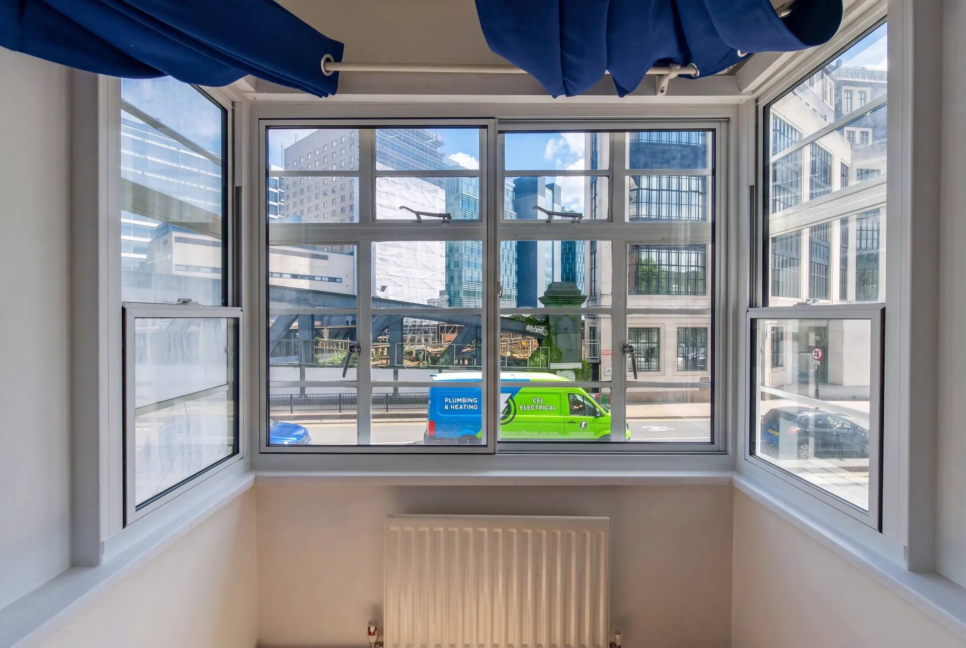Crittall bay on a main road — secondary glazing in Southwark, London Crittall-style bay window with secondary glazing facing a busy city road and glass towers