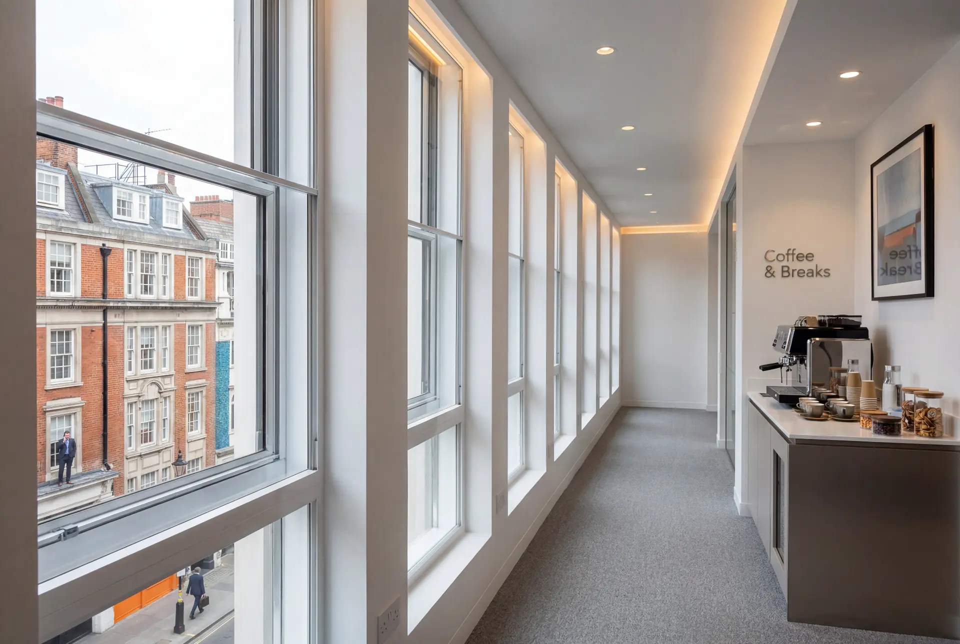 Corridor sash run — secondary glazing in Fitzrovia, London Office corridor lined with tall secondary glazed sash windows overlooking a red brick street