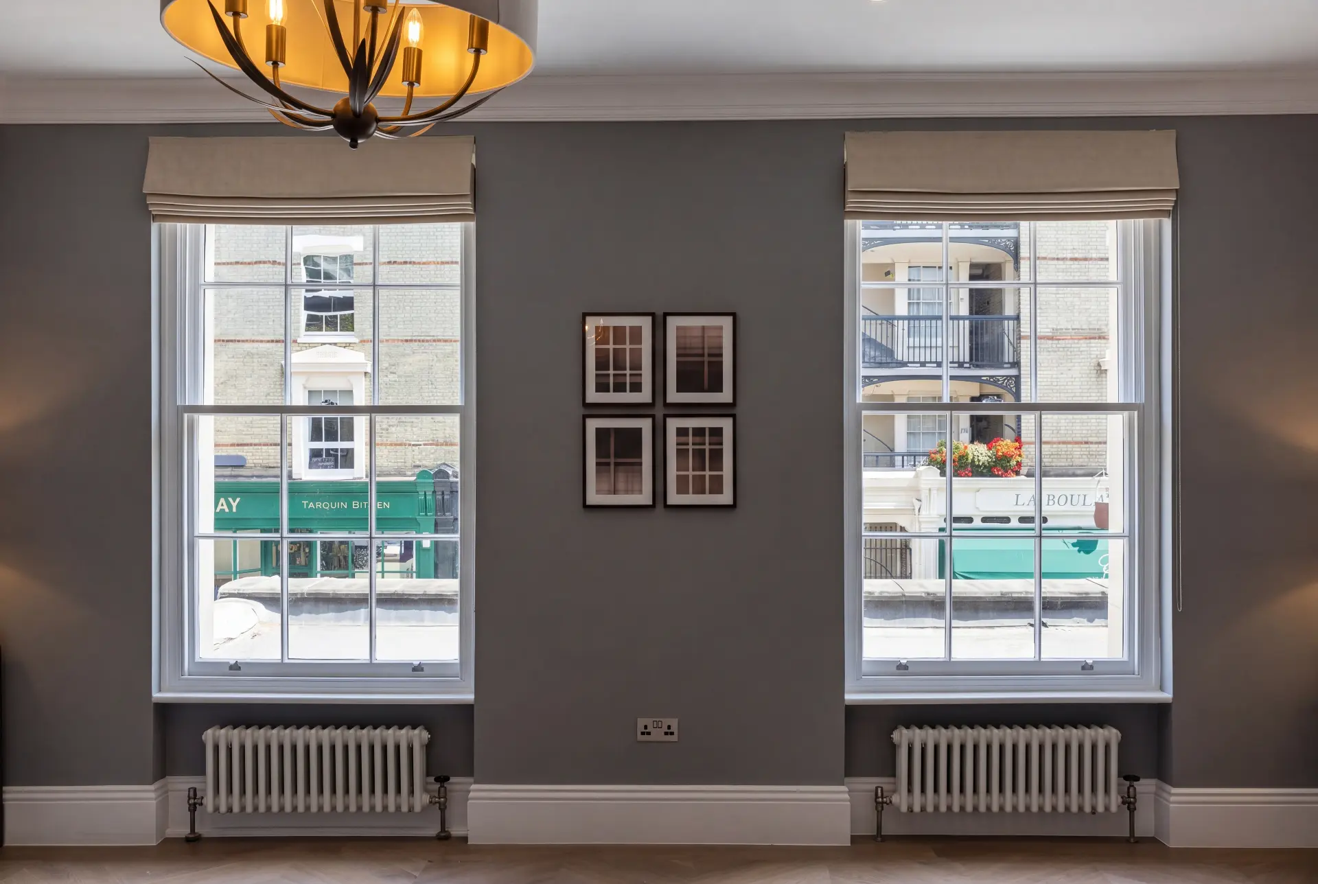 Above the shopfront — secondary glazing in Marylebone, London Two tall sash windows with secondary glazing above a London shopfront