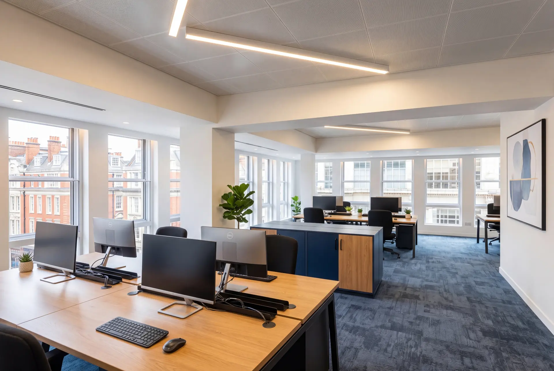 Open plan office run — secondary glazing in Mayfair, London Open plan office with secondary glazing across a run of tall windows facing period buildings