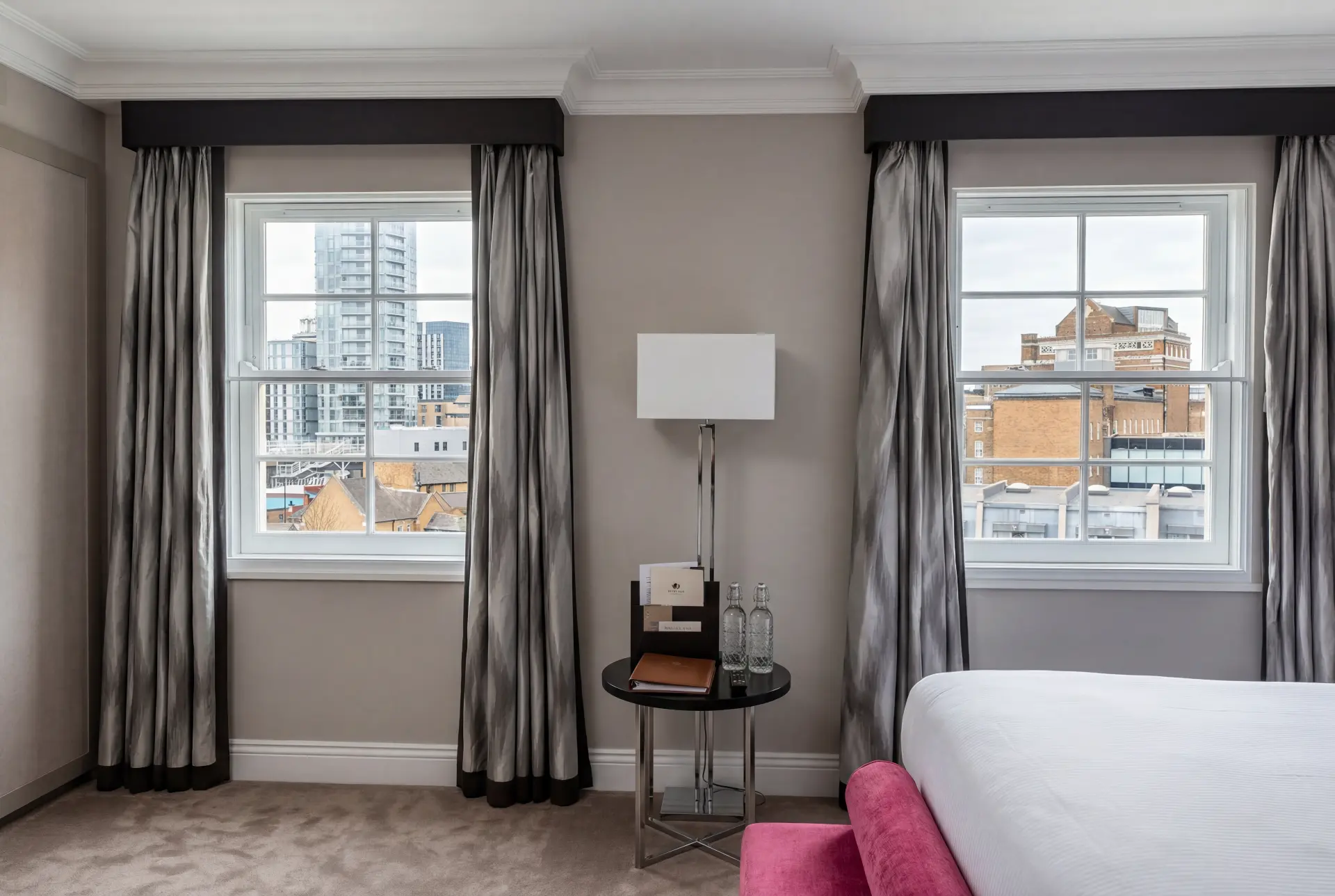 City-view bedroom — secondary glazing in Southwark, London Hotel-style bedroom with two secondary glazed sash windows facing a city skyline