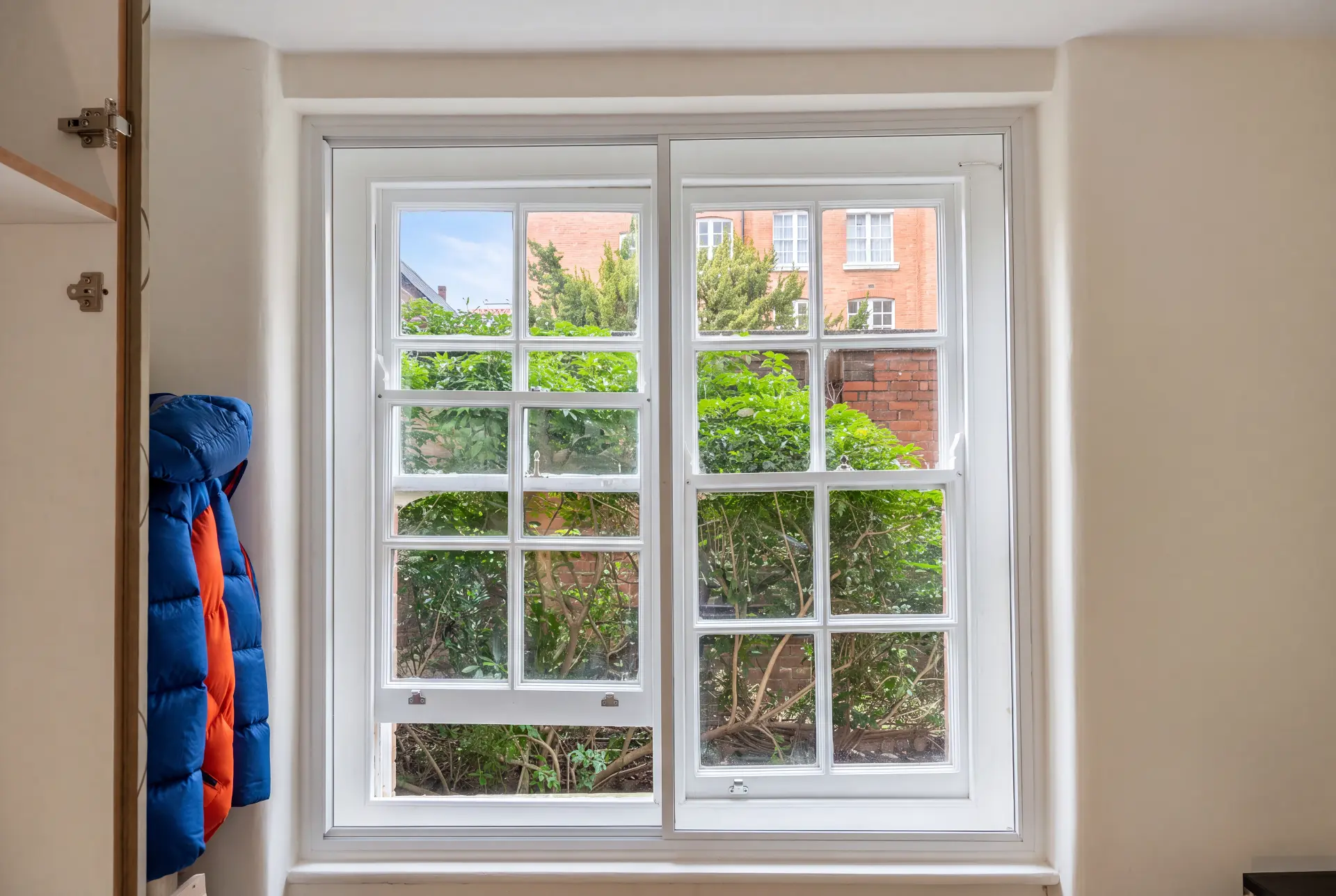Georgian bar sash — secondary glazing in Chiswick, London Georgian bar sash window with secondary glazing behind, looking onto a garden