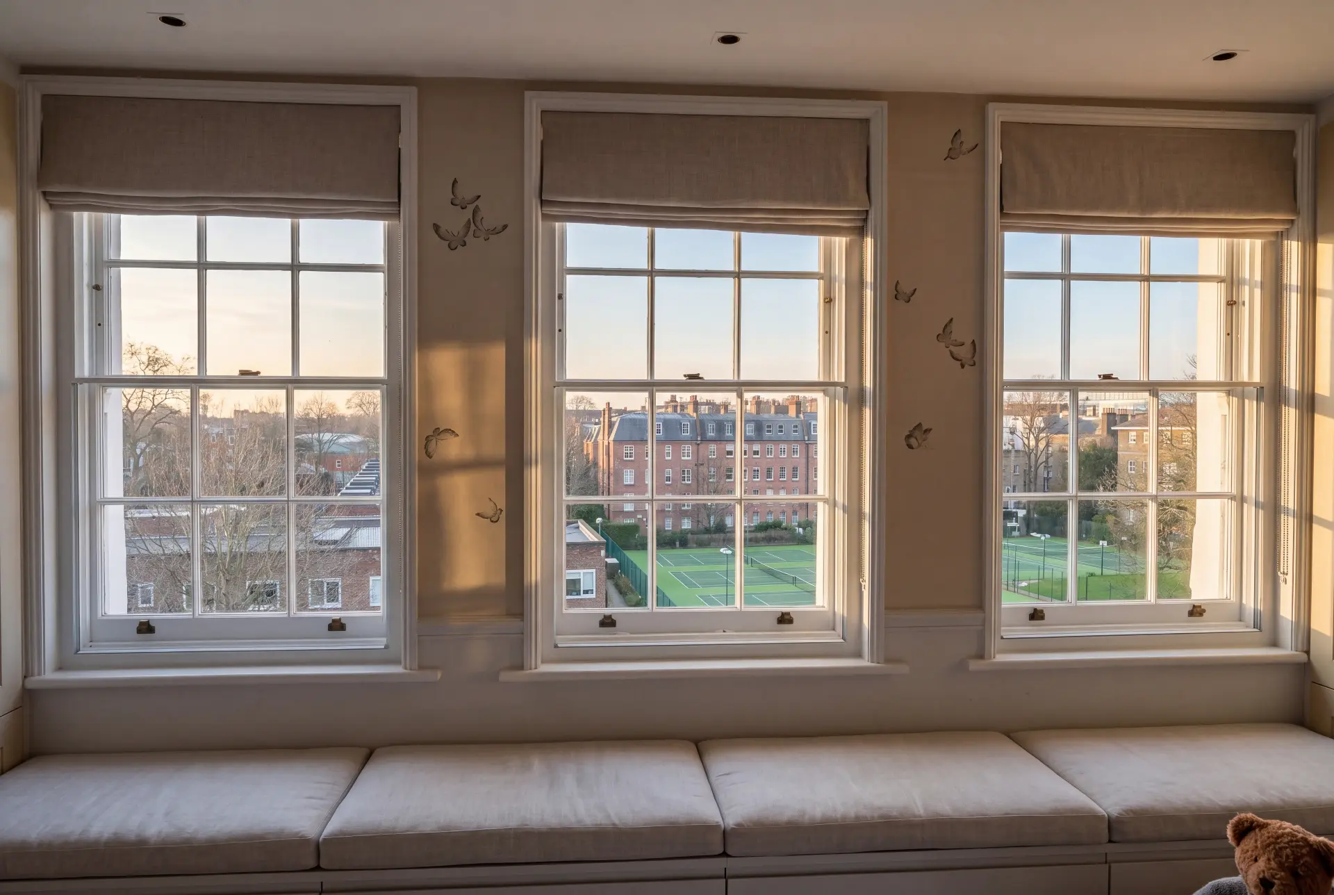 Window seat trio — secondary glazing in Richmond, London Three Georgian bar sash windows with secondary glazing above a long window seat