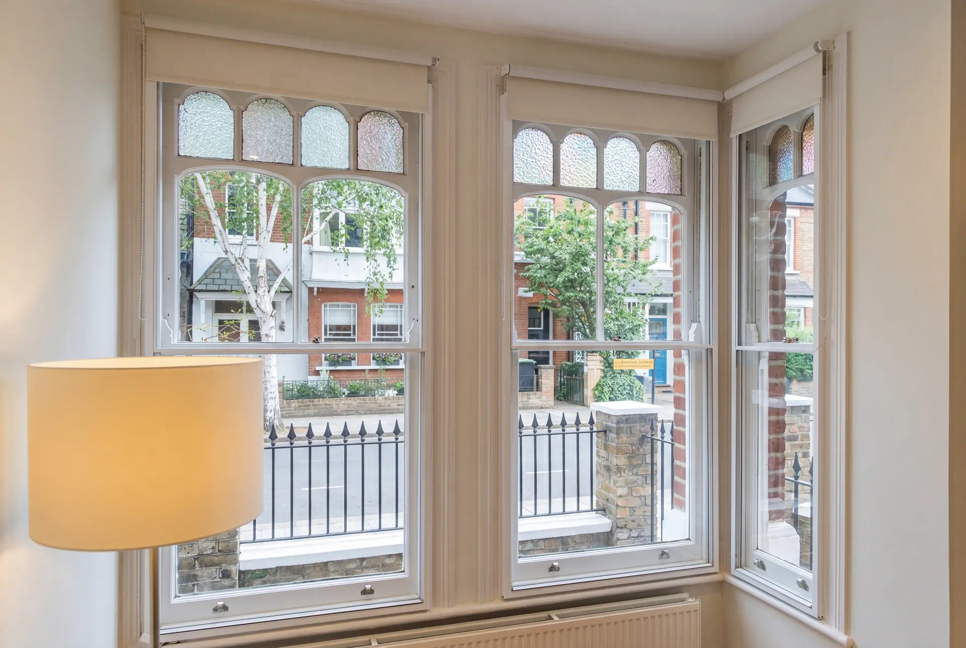 Stained glass bay — secondary glazing in Ealing, London Victorian bay window with stained glass toplights and secondary glazing facing a residential street