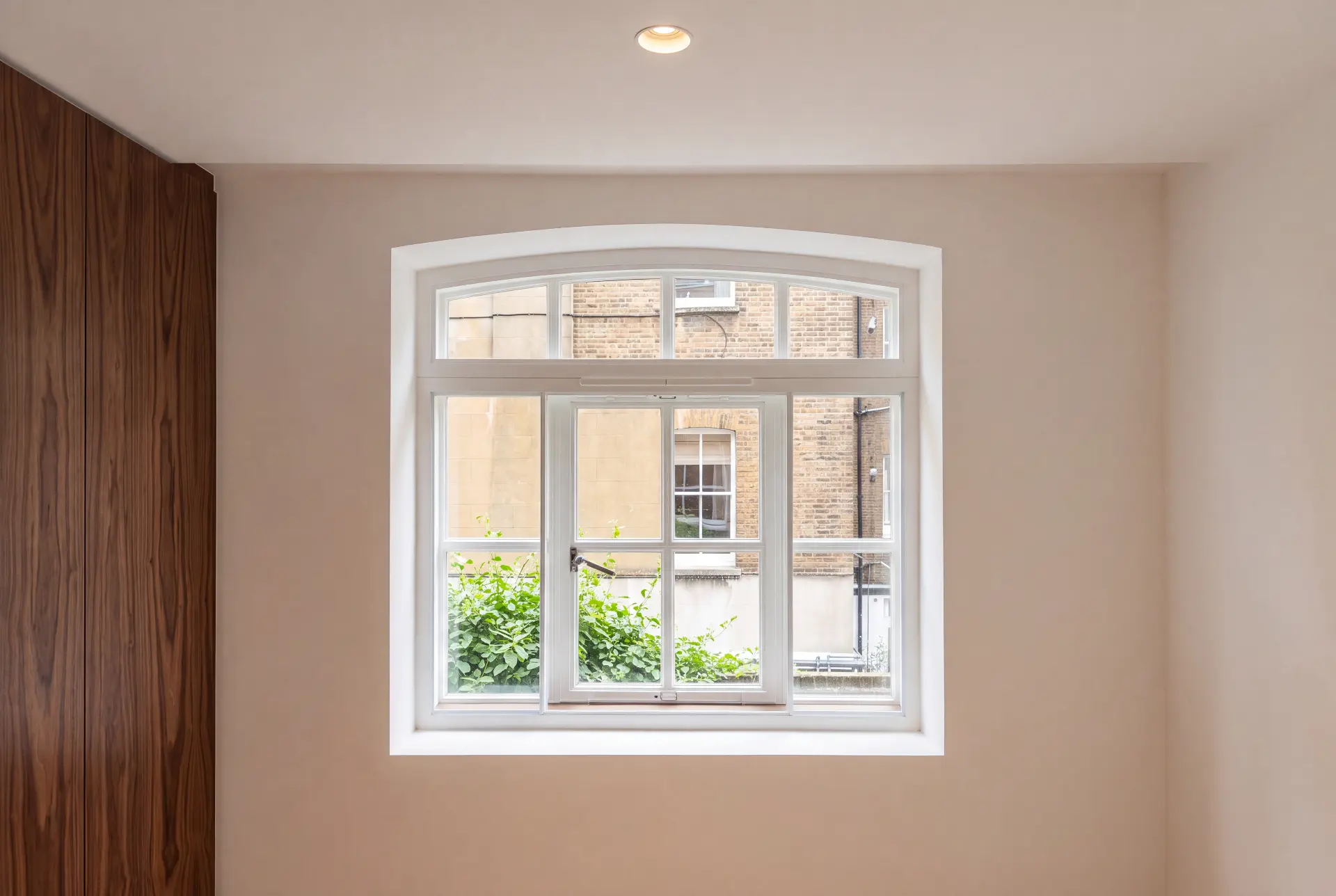Arched head window — secondary glazing in Marylebone, London Arched head window fitted with slimline secondary glazing in a modern London interior