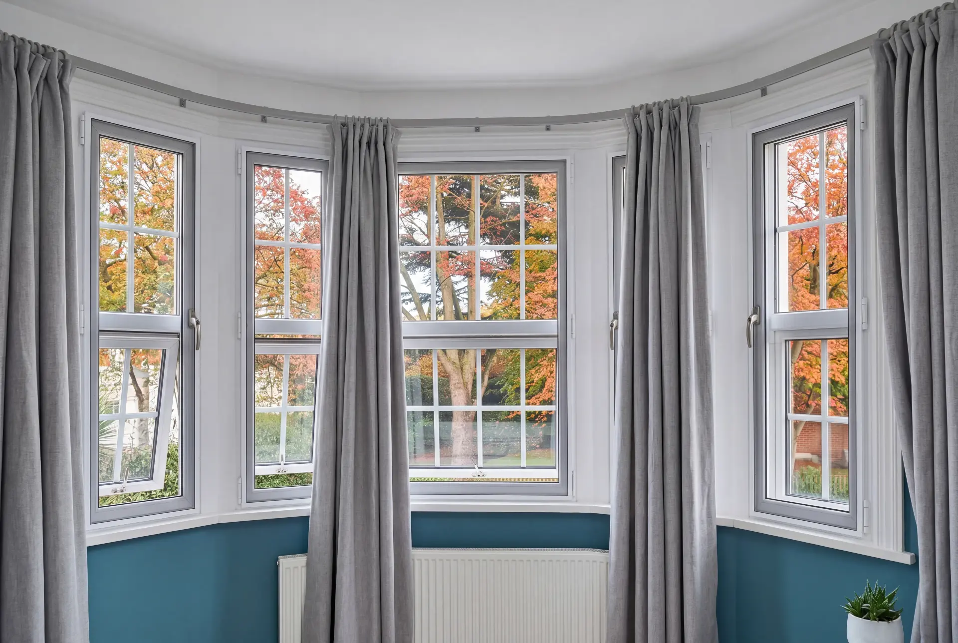 Five-panel bow bay — secondary glazing in Blackheath, London Five-panel bow bay window with secondary glazing looking onto autumn trees