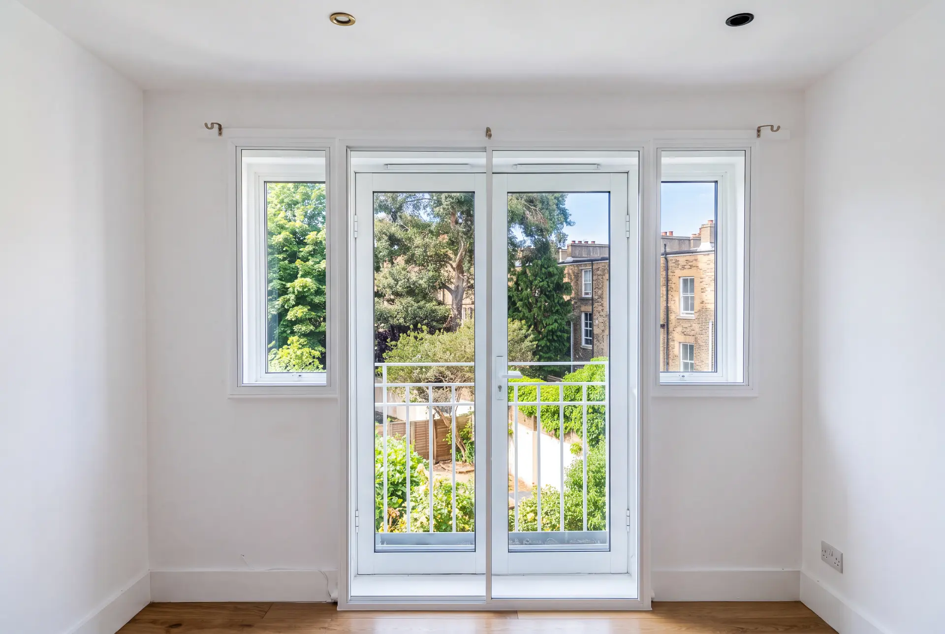French balcony doors — secondary glazing in North London, London Secondary glazing fitted to white French balcony doors and flanking casement windows in a London flat