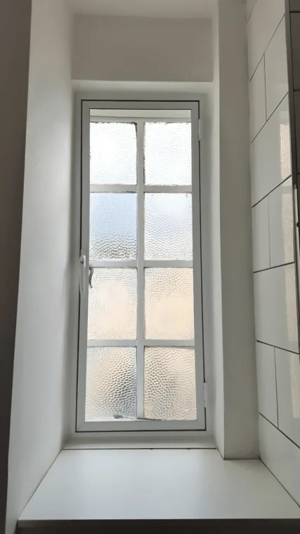 Bathroom window with frosted acoustic secondary glazing for privacy and noise reduction