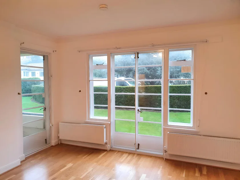 Modern patio doors with secondary glazing in bright room overlooking garden